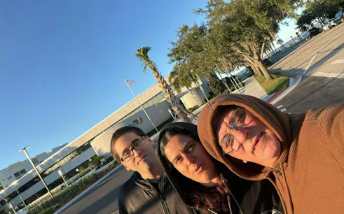 Self-guided city exploration game participants in Sanford, street view with trees and building.