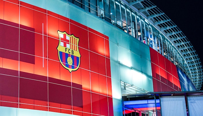 Camp Nou facade in Barcelona, showcasing the stadium's iconic architecture.