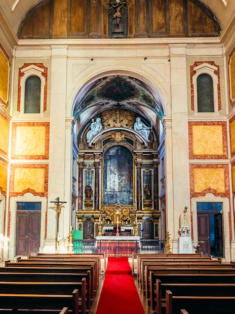 Interior of St George's Castle Church with ornate altar and pews, Lisbon, Portugal.