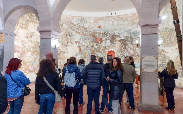 Guests viewing historical mural inside Skanderbeg National Museum, Kruja.