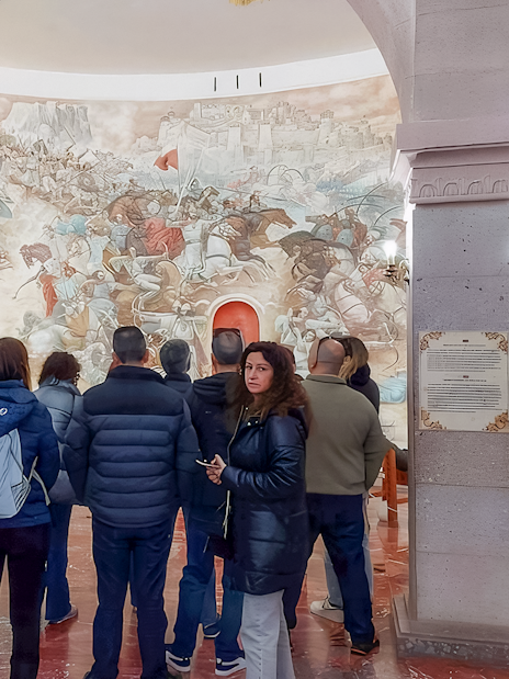 Guests viewing historical mural inside Skanderbeg National Museum, Kruja.