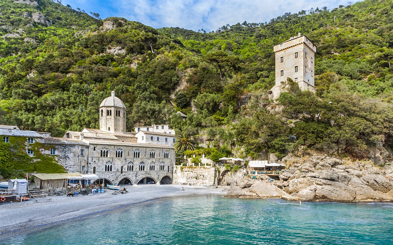 Abbazia di San Fruttuoso with surrounding greenery and beach in Liguria, Italy.