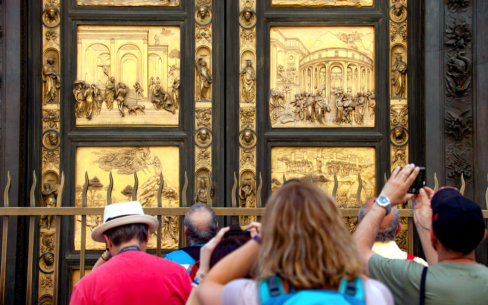 Tourists photographing the Gates of Paradise at Florence's Baptistery.