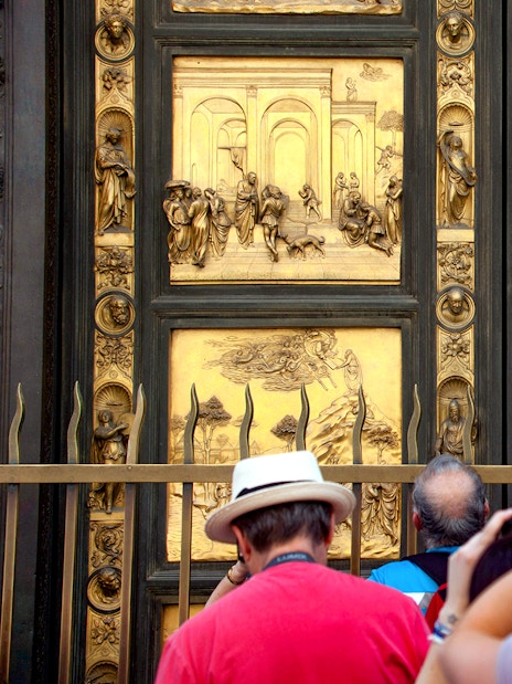 Tourists photographing the Gates of Paradise at Florence's Baptistery.
