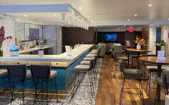 Primeclass Lounge bar area with seating at JFK International Airport, New York.