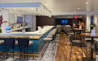 Primeclass Lounge bar area with seating at JFK International Airport, New York.