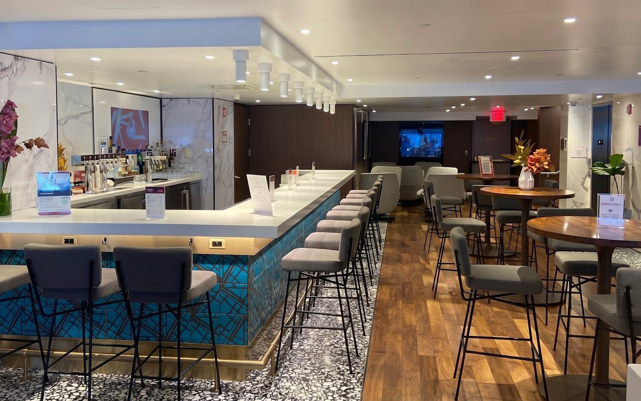 Primeclass Lounge bar area with seating at JFK International Airport, New York.