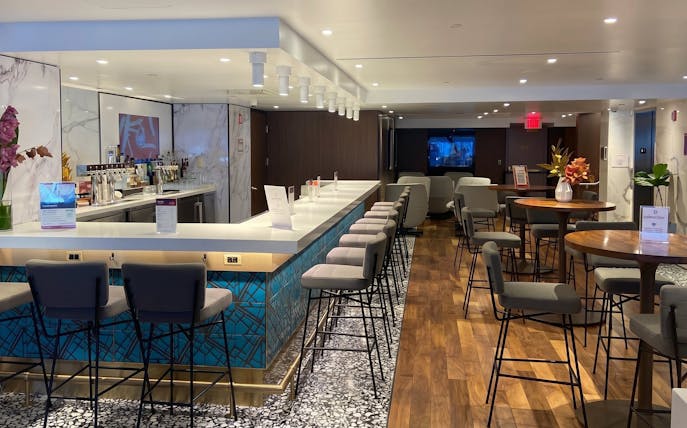 Primeclass Lounge bar area with seating at JFK International Airport, New York.