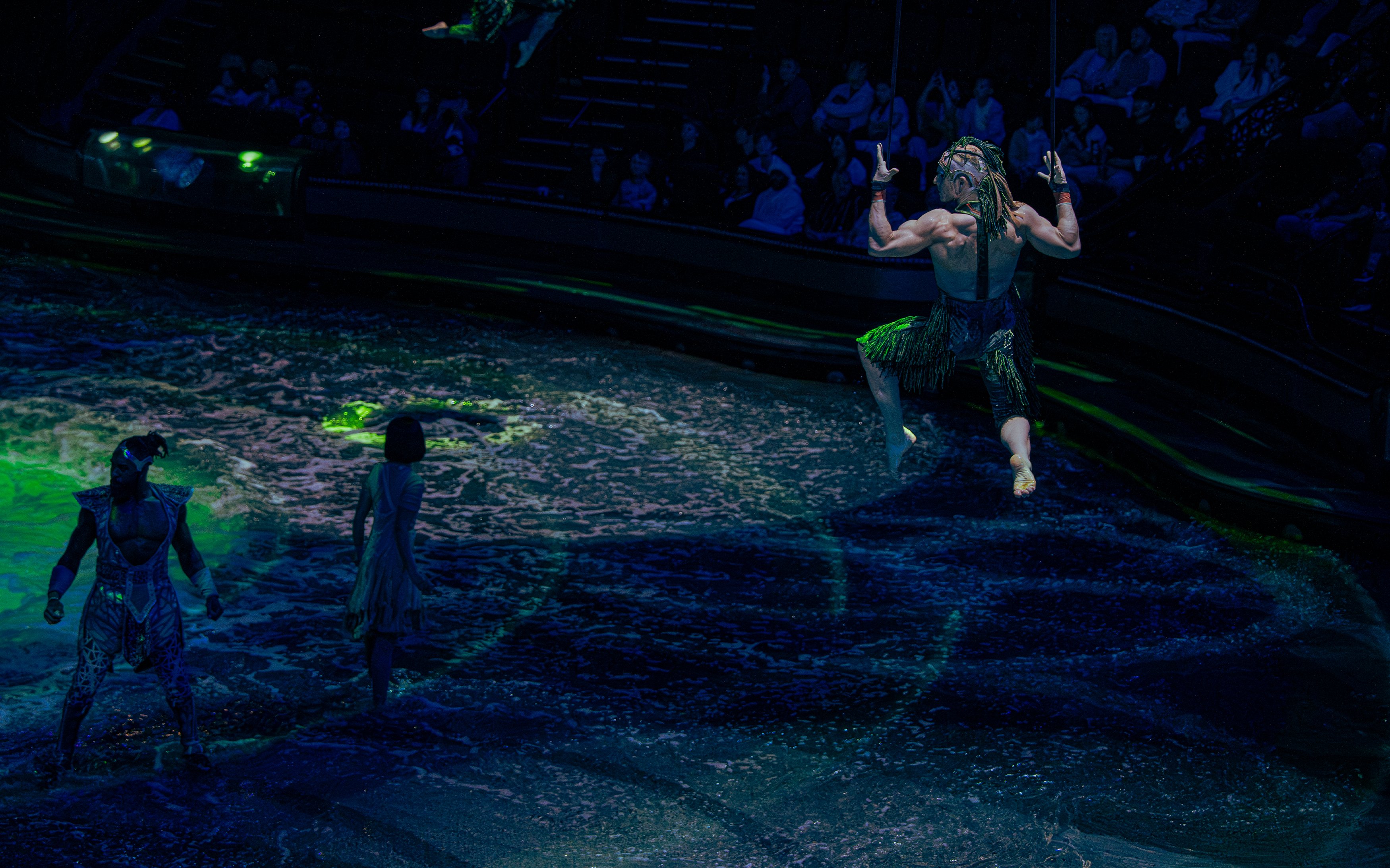 Acrobats performing over water at La Perle show in Dubai.
