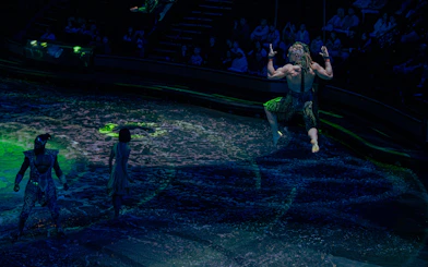 Acrobats performing over water at La Perle show in Dubai.