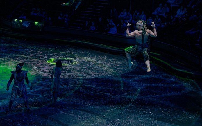 Acrobats performing over water at La Perle show in Dubai.