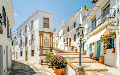 Whitewashed buildings and cobblestone street in Frigiliana, Malaga, Andalusia, Spain.