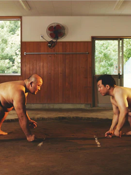 Sumo wrestlers face off in a dohyo ring during a training session in Kawasaki.