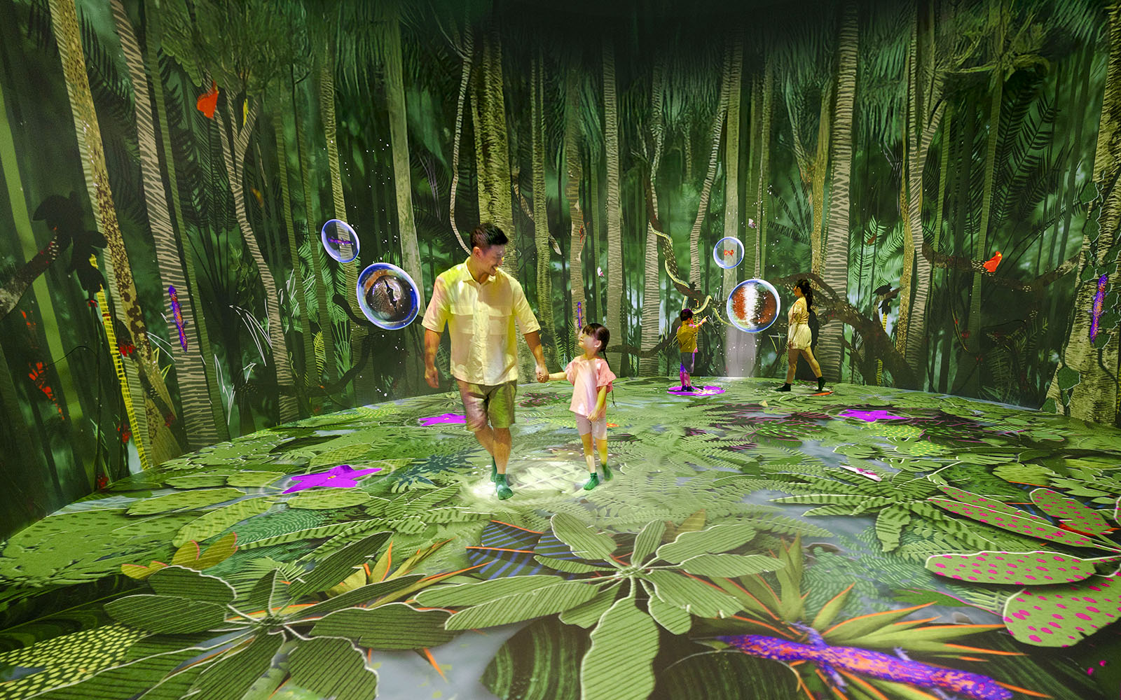 Interactive forest exhibit with people exploring digital canopy projections.