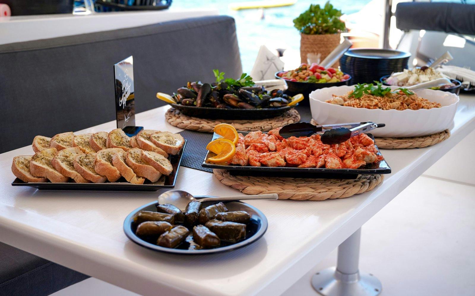 Assorted Mediterranean dishes served on a catamaran during the Ierapetra to Chrissi Island cruise.