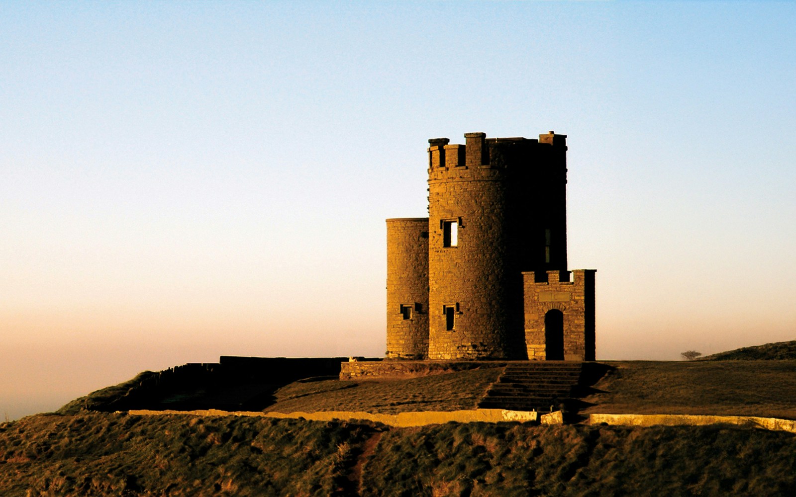 Stone tower at sunset on the Cliffs of Moher, Burren, Ireland.