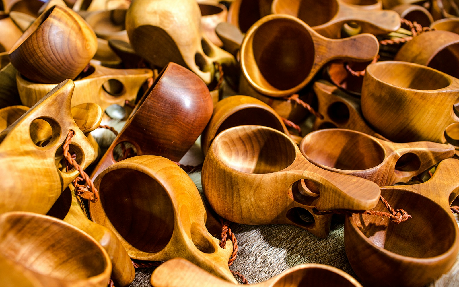 Kuksa wooden drinking cups from Finland displayed in a pile.