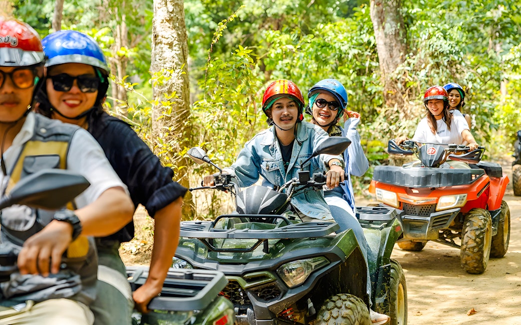 ATV riders exploring a forest trail near Flying Hanuman, Phuket.