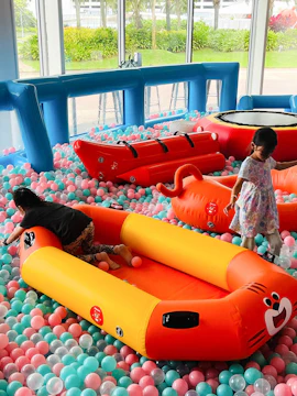 Children playing in an inflatable playground at Bounce Singapore.