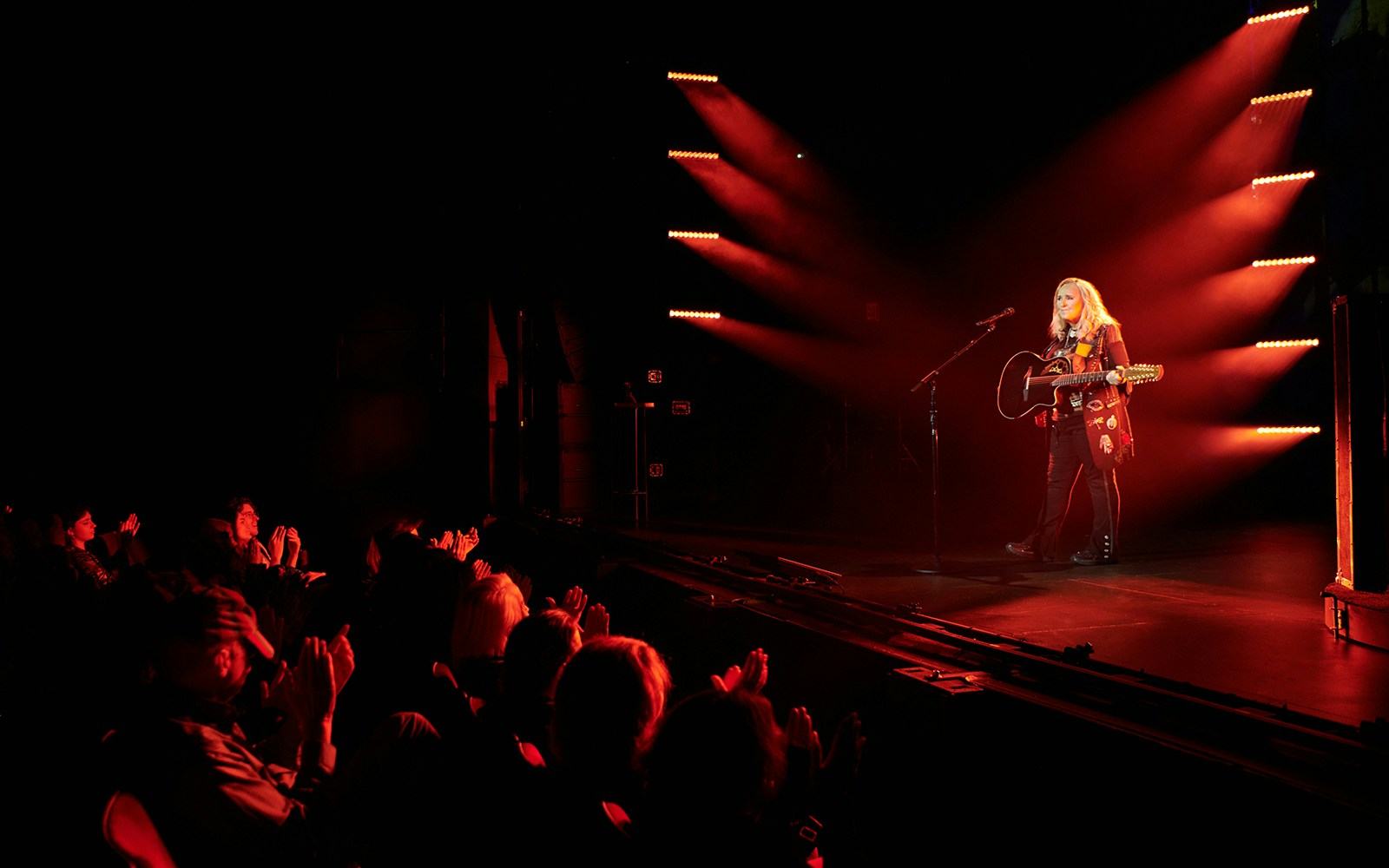 Musician performing on stage with guitar, audience clapping, "Melissa Etheridge: My Window" tour.