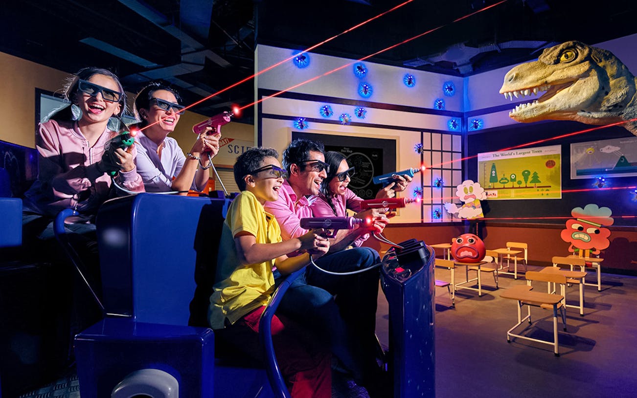 Visitors enjoying a 3D laser shooting game at IMG Worlds of Adventure.