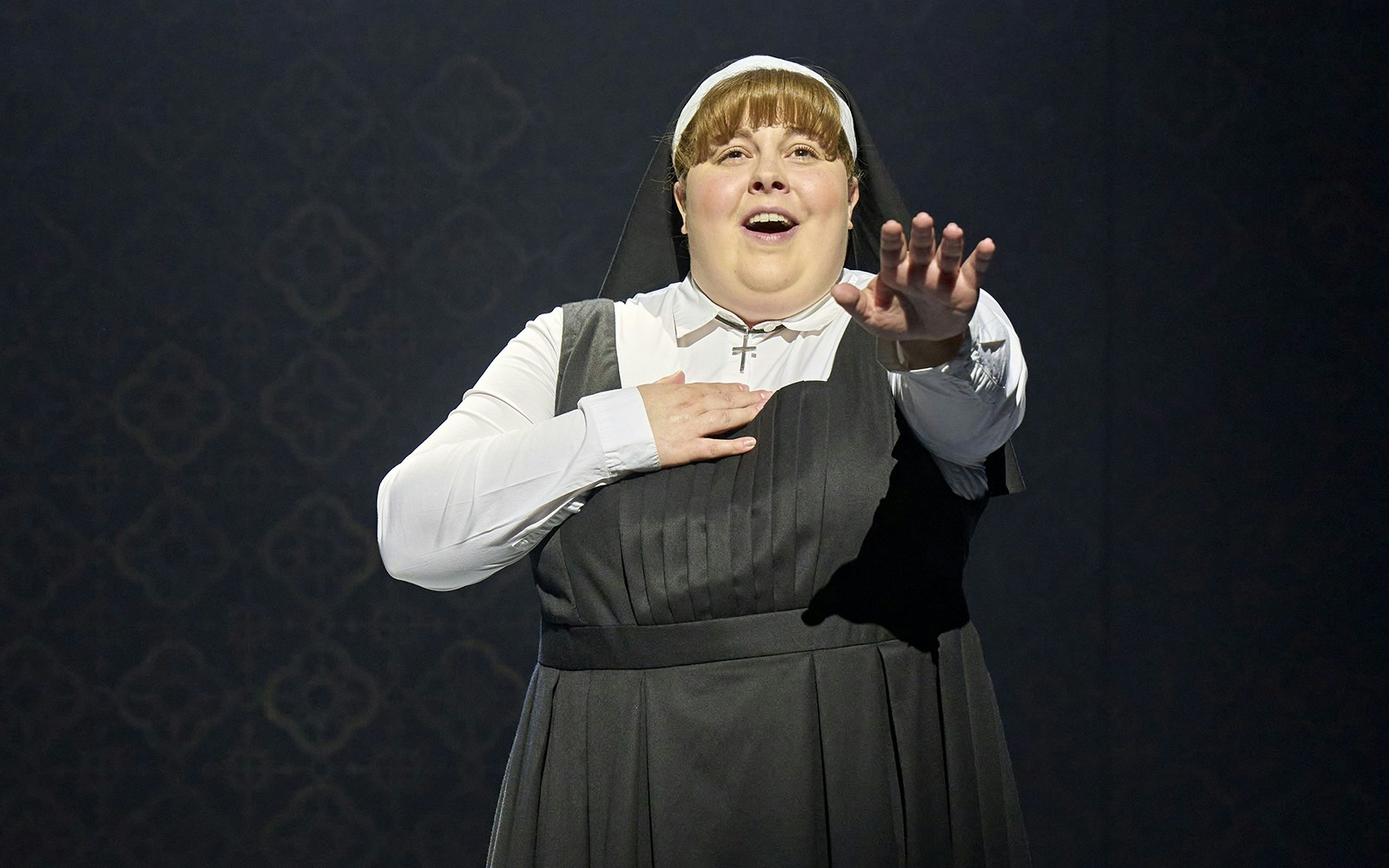 Nun performing on stage in Sister Act musical.
