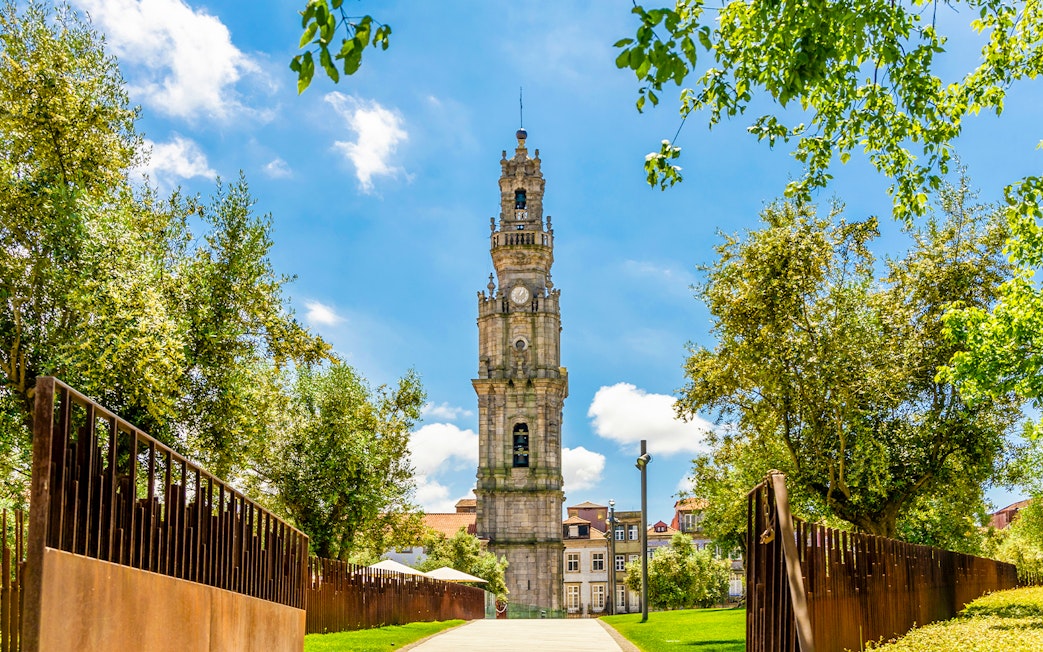 Clerigos Tower surrounded by trees in Porto, Portugal.