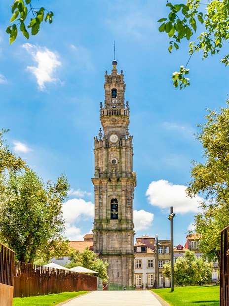 Clerigos Tower surrounded by trees in Porto, Portugal.