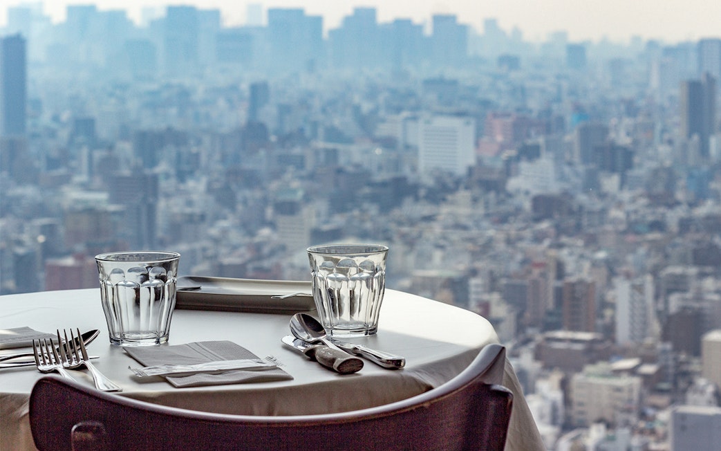 Dining table set with cityscape view from Tokyo Skytree restaurant.