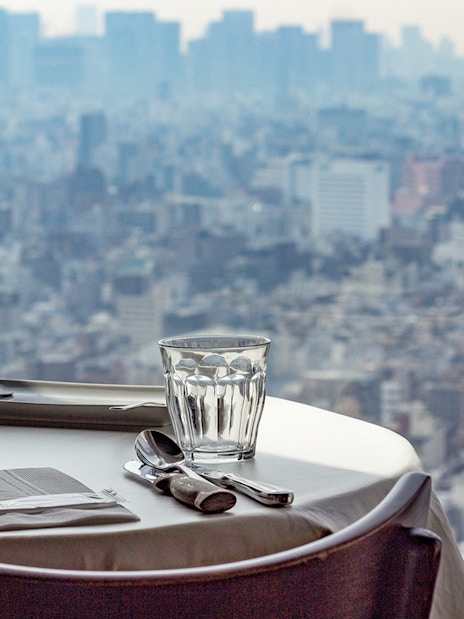 Dining table set with cityscape view from Tokyo Skytree restaurant.
