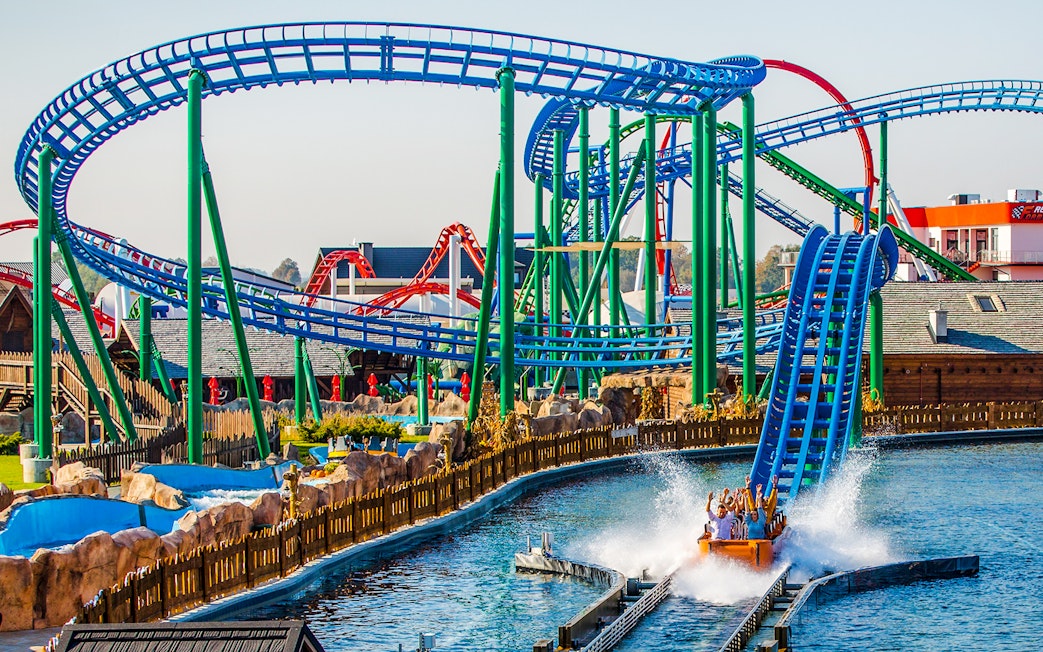 Roller coaster and water ride at Energylandia Amusement Park, Poland.