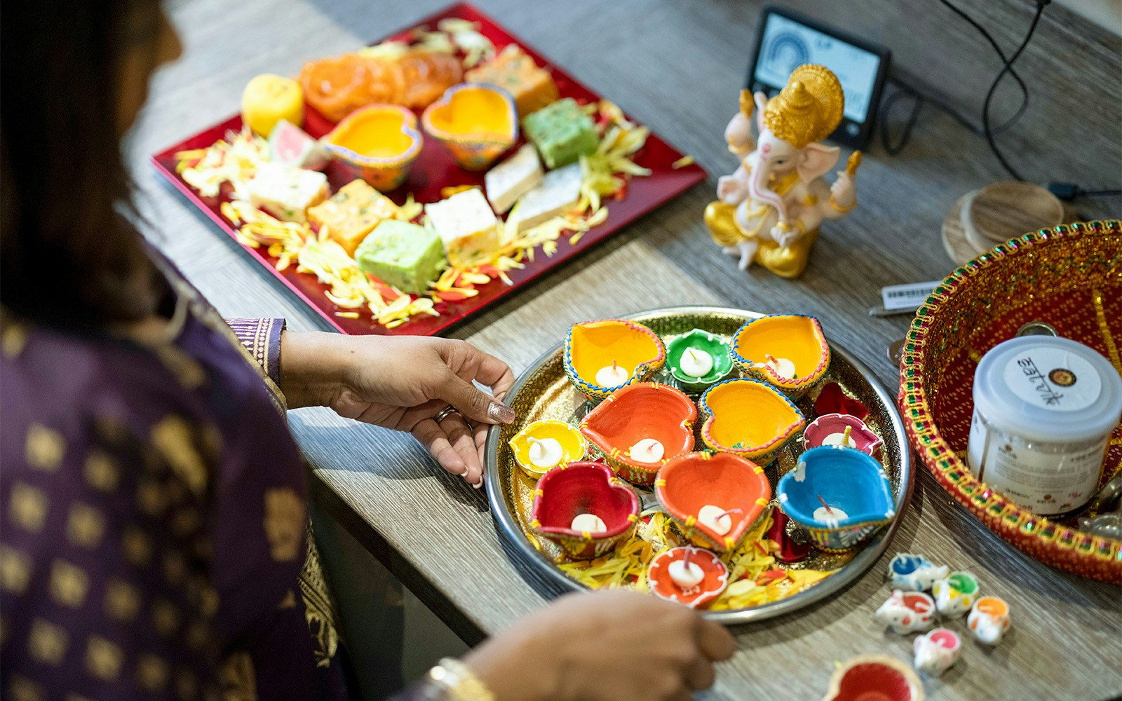 People celebrating Diwali with fireworks and lanterns in a vibrant city setting.