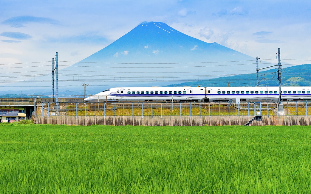 Bullet train passing in front of Mount Fuji on route to Tokyo.