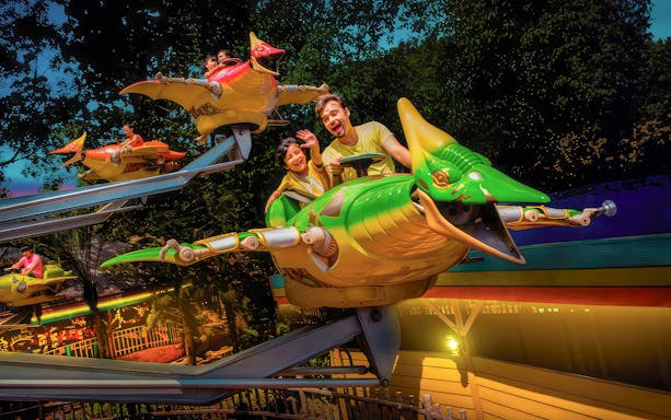 Father and son on Flying dinosaur ride