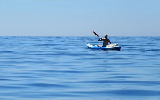 Person kayaking on open water during a Dubai tour.