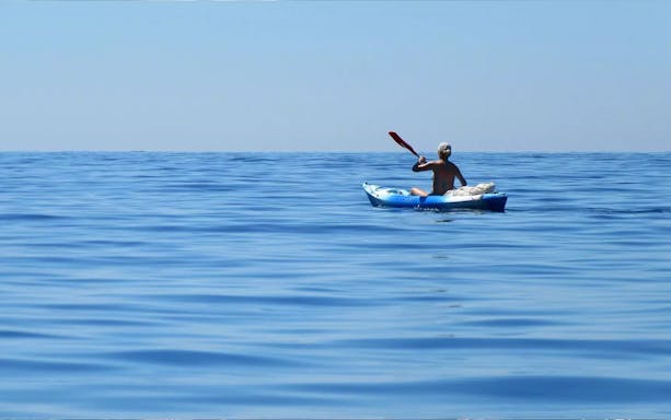 Person kayaking on open water during a Dubai tour.