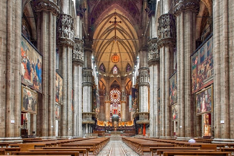 Duomo Milan Cathedral interior with ornate arches and stained glass windows.