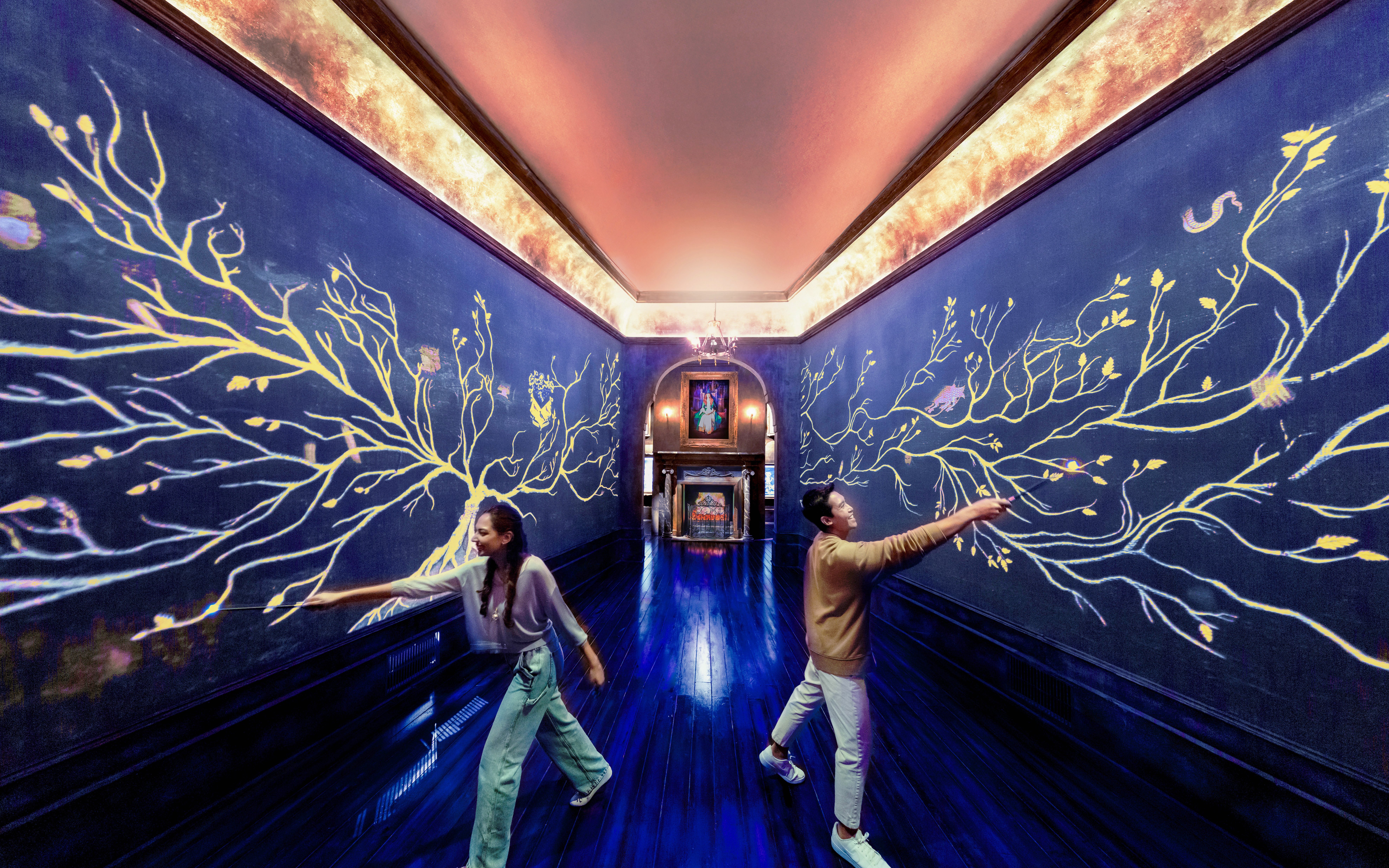 Visitors interact with magical wall art at Harry Potter Visions of Magic exhibit.