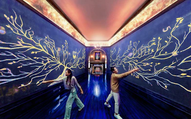 Visitors interact with magical wall art at Harry Potter Visions of Magic exhibit.