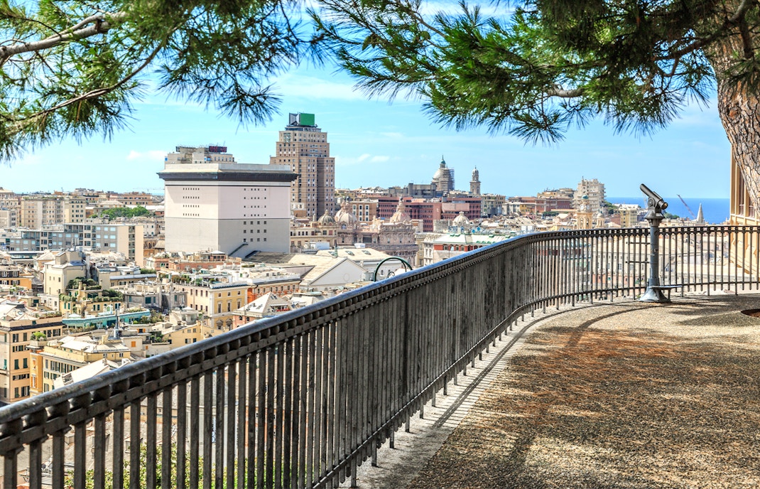 View of Genoa from Spianata Castelletto, showcasing cityscape and harbor.