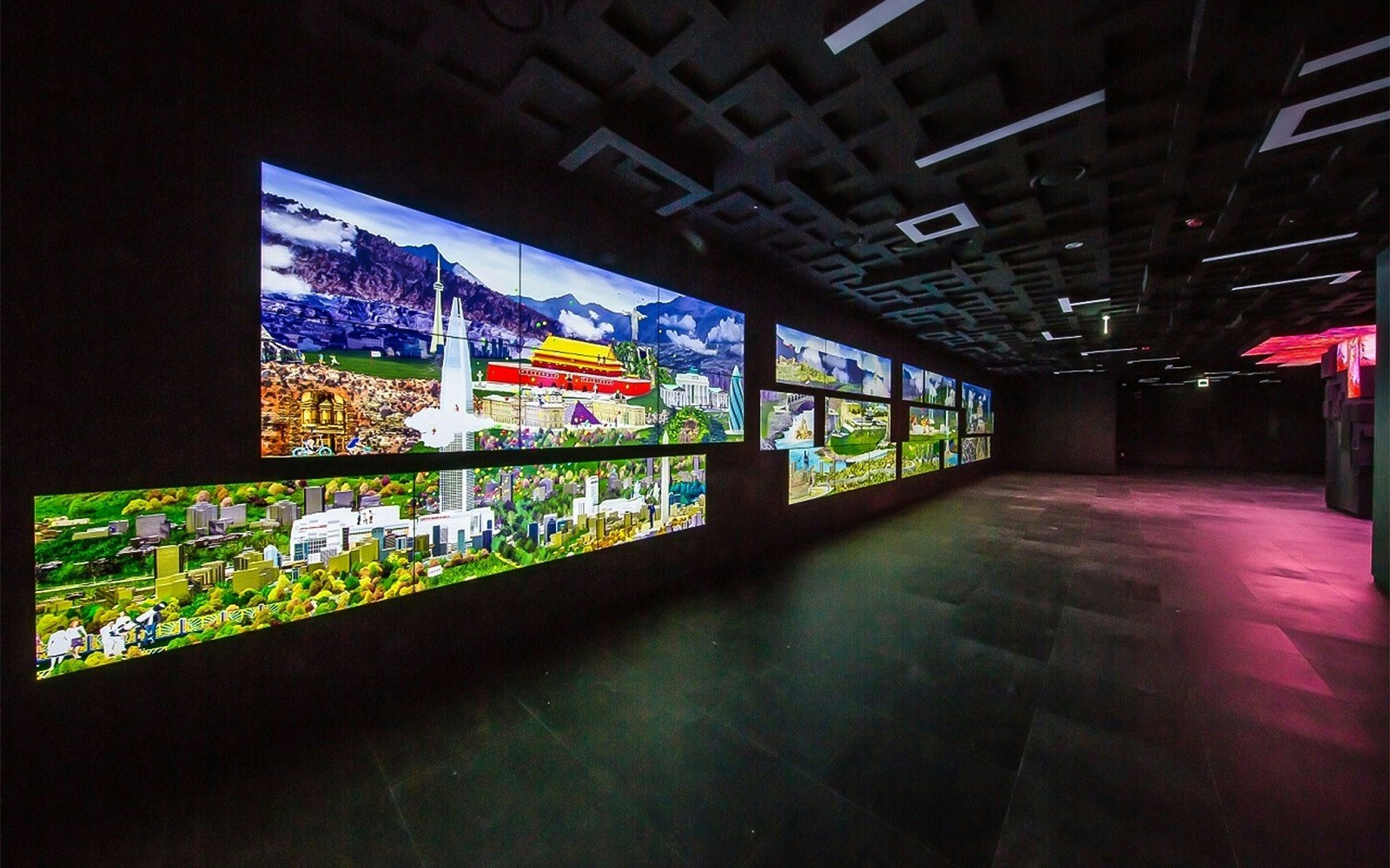 Digital displays at Lotte World Tower Seoul Sky showing cityscapes and landmarks.