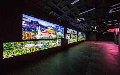 Digital displays at Lotte World Tower Seoul Sky showing cityscapes and landmarks.