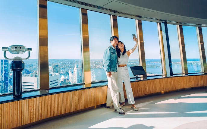 Couple taking a selfie on the viewing deck of Sydney Tower Eye.