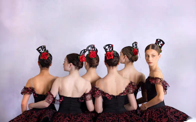 Ballet dancers in ornate costumes at a gala performance in Prague's Old Town.
