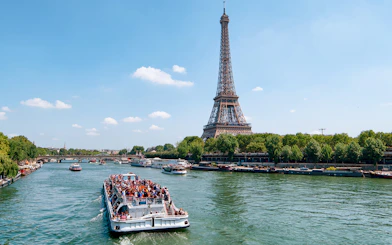 Seine River cruise with view of Eiffel Tower and Parisian architecture.
