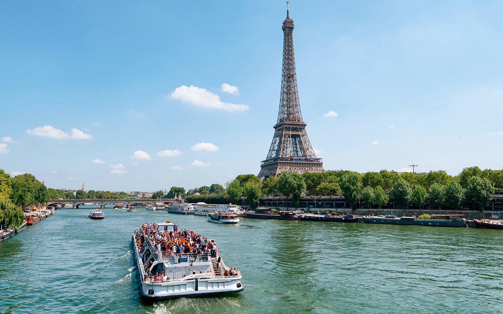 Seine River cruise with Eiffel Tower and Parisian architecture in view.