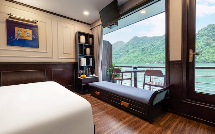 Senior Suite interior with balcony view of Halong Bay on Amanda Luxury Cruise.