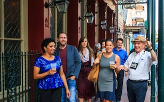 Group enjoying a craft cocktail walking tour in New Orleans.