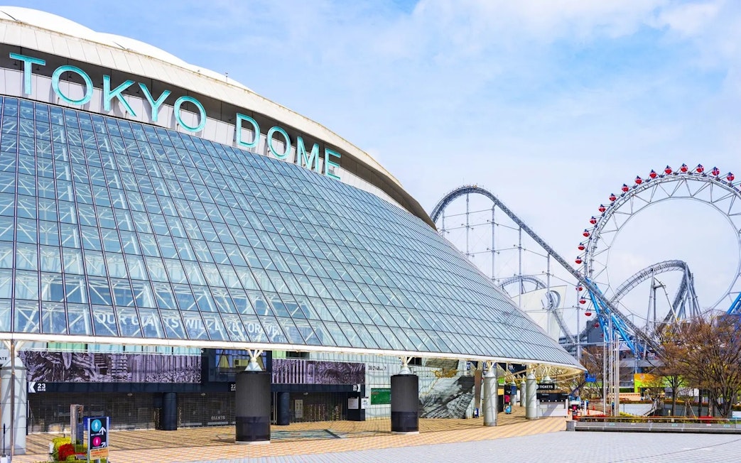 Tokyo Dome exterior with roller coaster in the background, Tokyo, Japan.