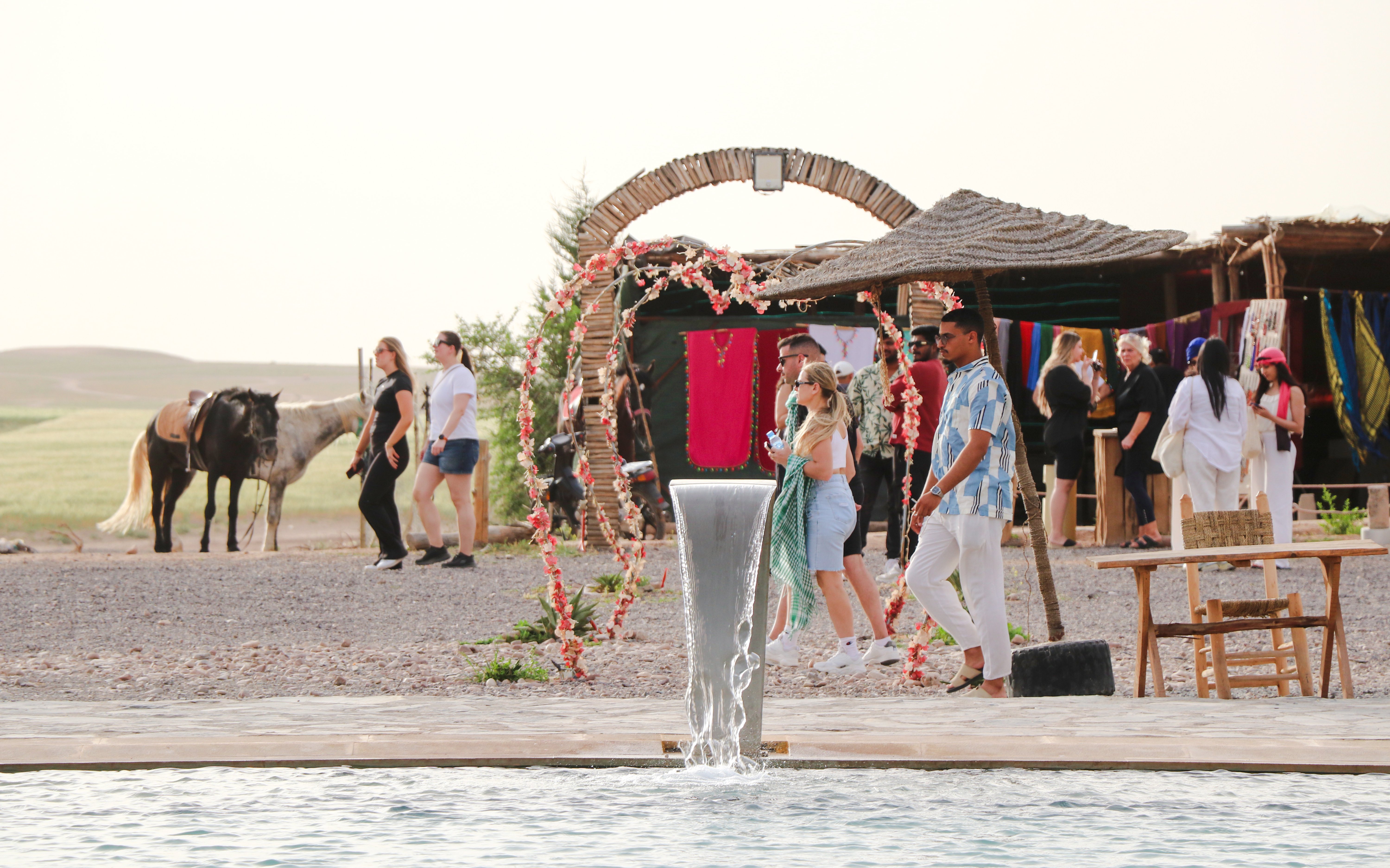 Safari lunch with camel ride and swimming pool in Agafay desert setting.